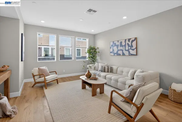 a dining room with furniture and wooden floor