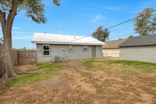 a view of a backyard with a fence