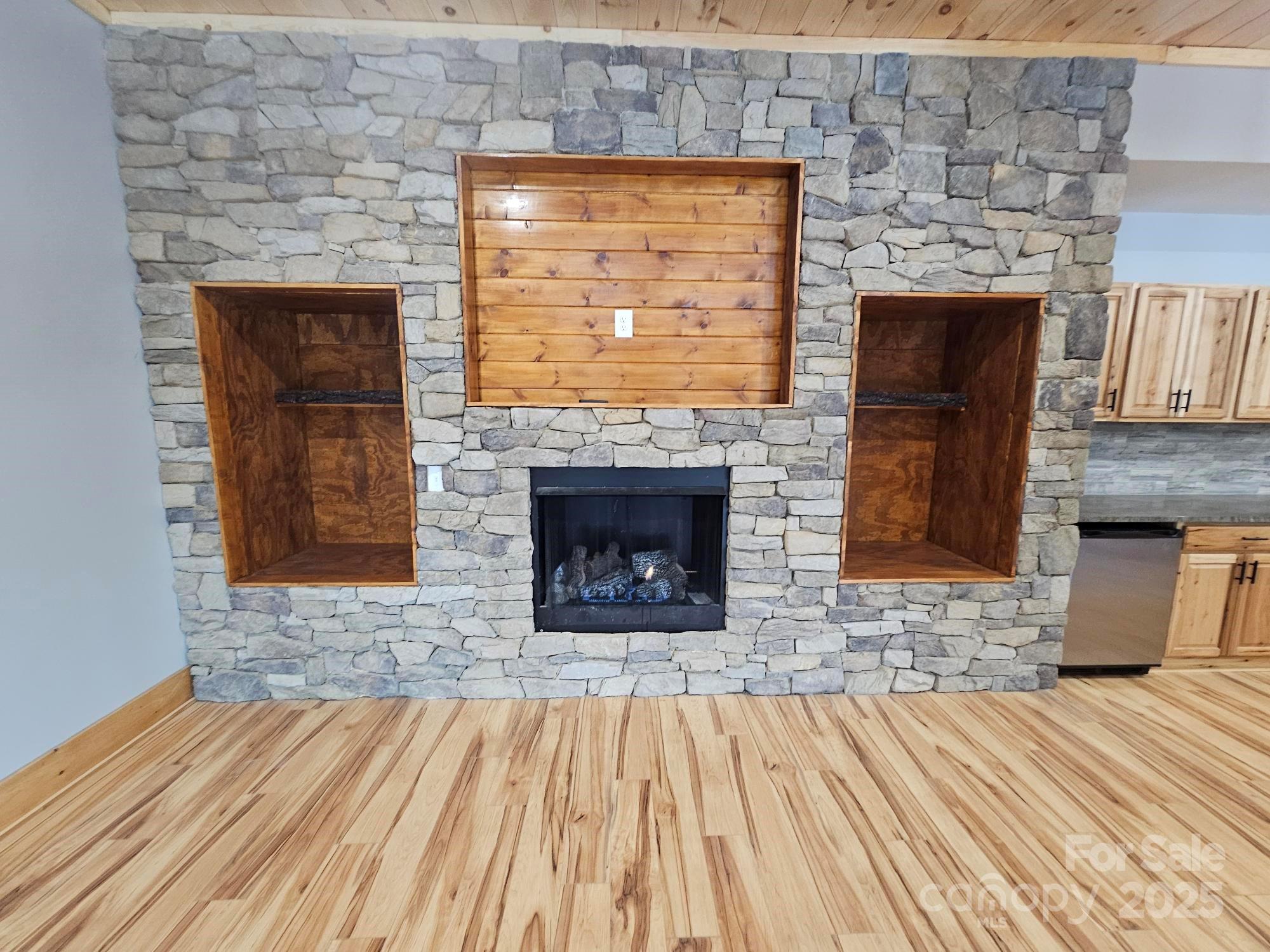 1076 Table View Drive, Unit 55 Morganton, NC 28655 - Photo 13 of 33 an empty room with wooden floor a fireplace and windows