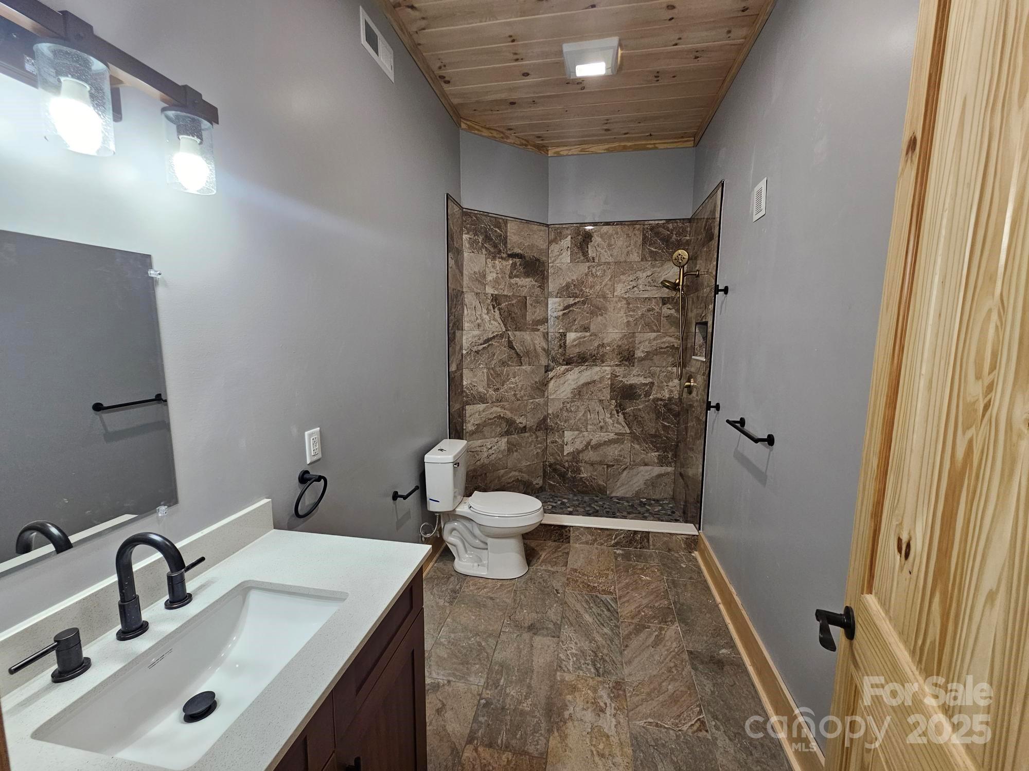 1076 Table View Drive, Unit 55 Morganton, NC 28655 - Photo 15 of 33 a bathroom with a sink and a mirror