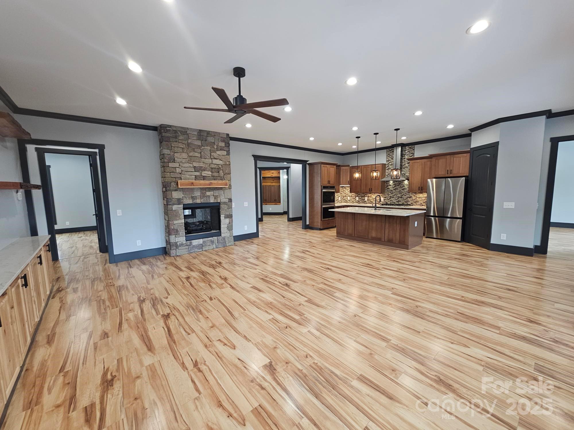 1076 Table View Drive, Unit 55 Morganton, NC 28655 - Photo 18 of 33 a view of a livingroom with furniture a ceiling fan and wooden floor