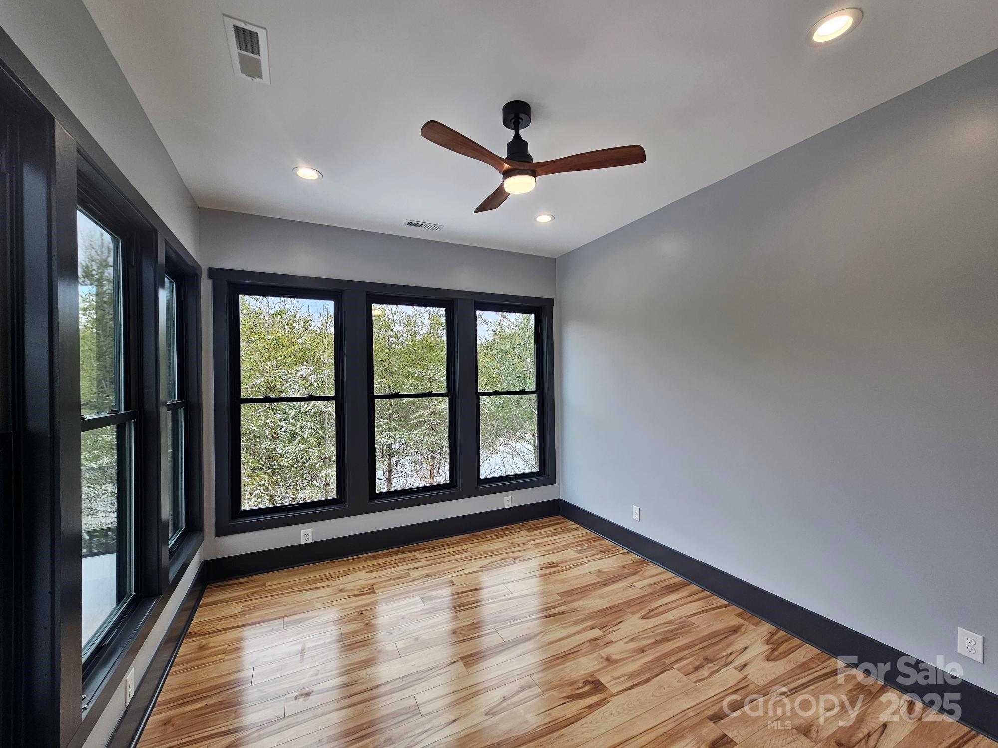1076 Table View Drive, Unit 55 Morganton, NC 28655 - Photo 19 of 33 a view of an empty room with wooden floor and a window