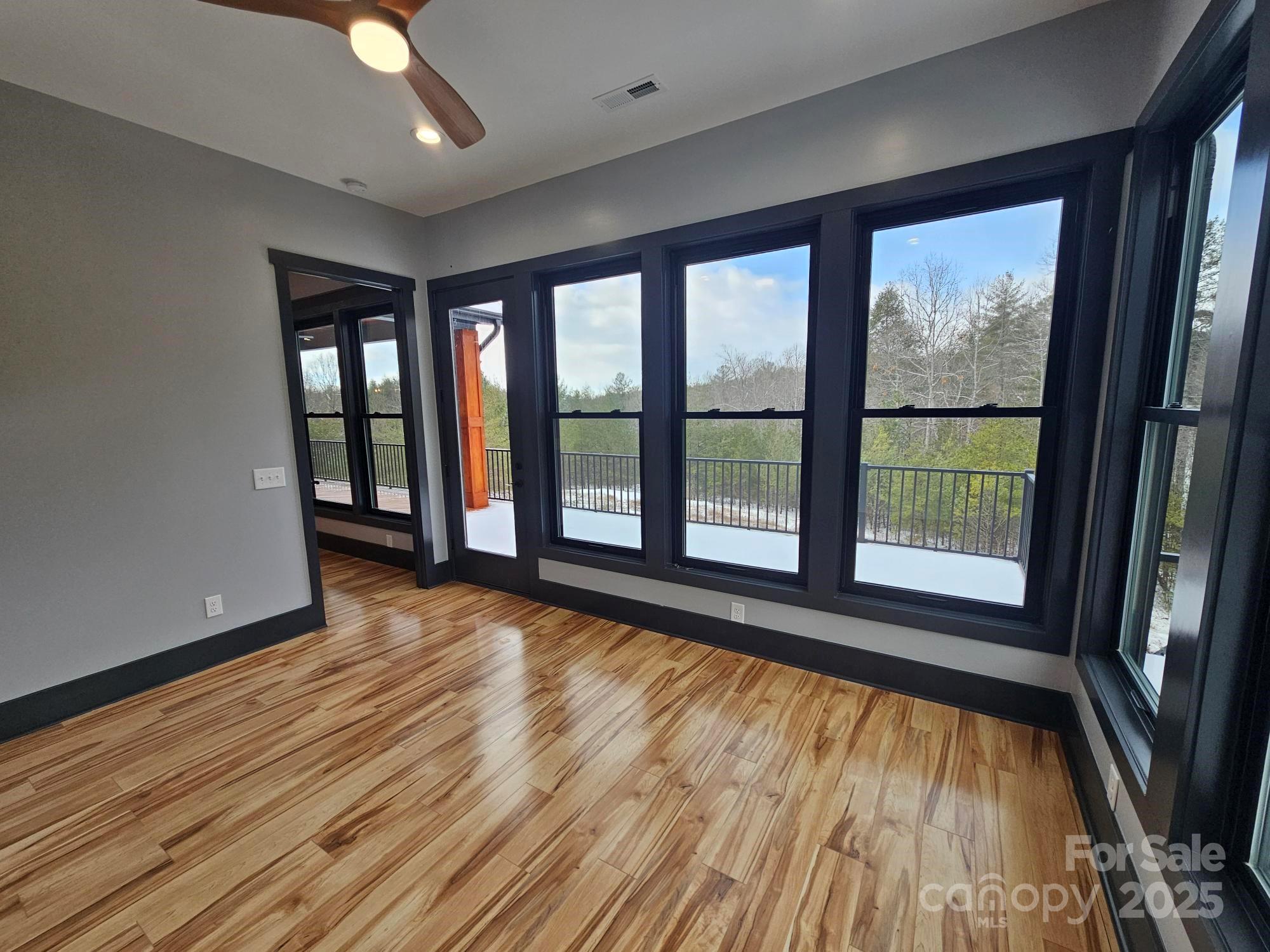 1076 Table View Drive, Unit 55 Morganton, NC 28655 - Photo 20 of 33 a view of an empty room with wooden floor and a window