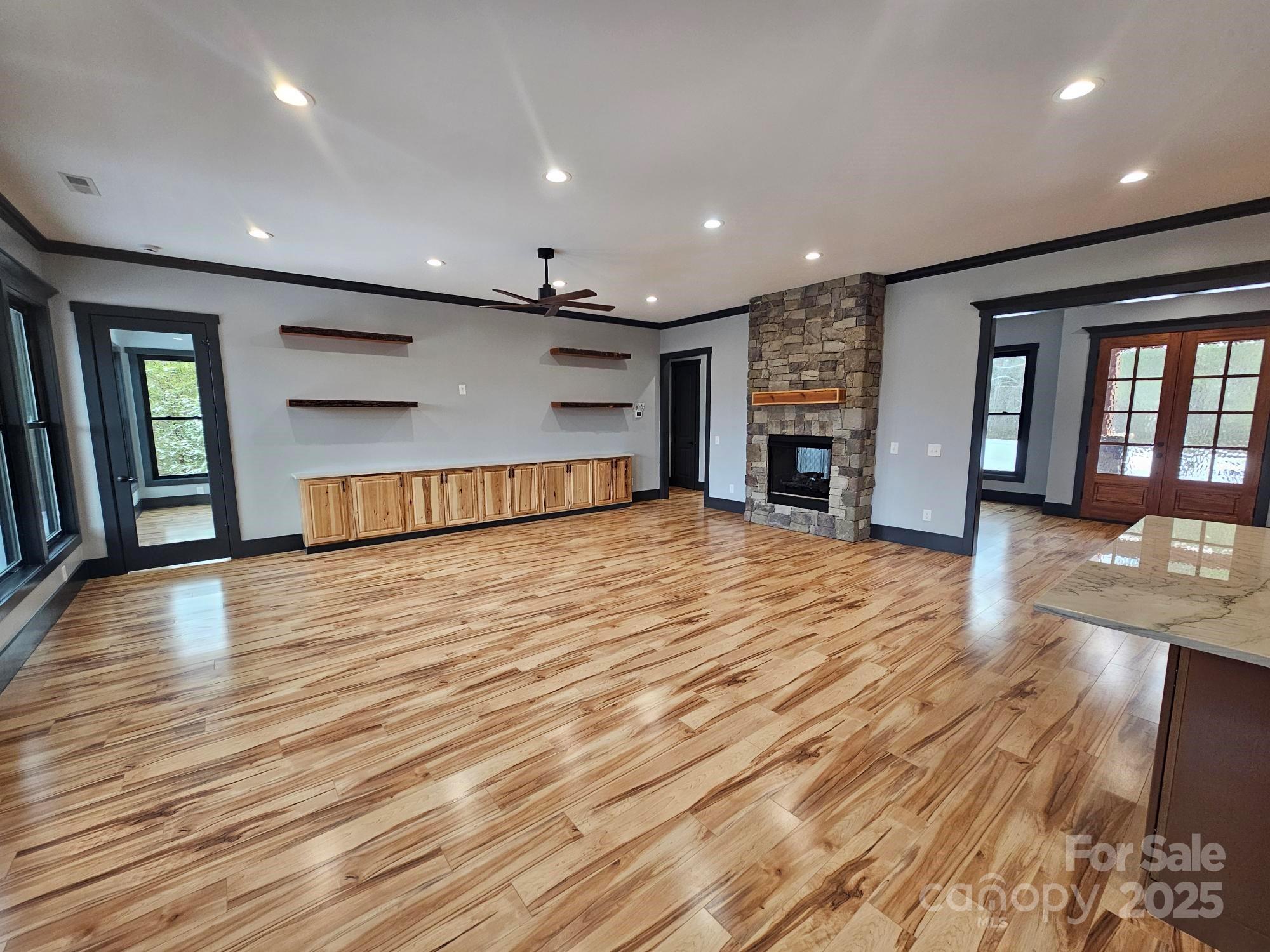 1076 Table View Drive, Unit 55 Morganton, NC 28655 - Photo 22 of 33 an empty room with wooden floor and fireplace