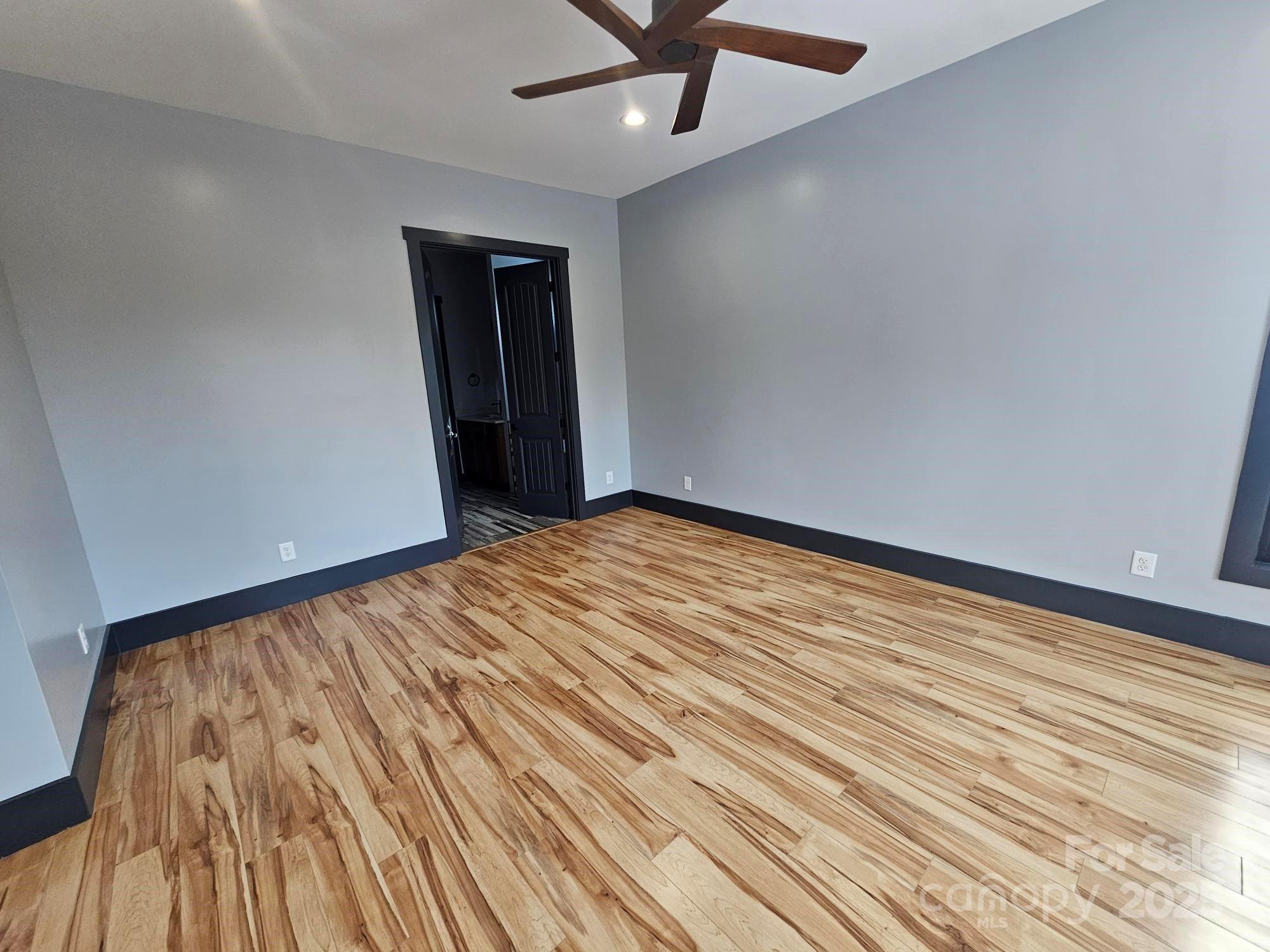 1076 Table View Drive, Unit 55 Morganton, NC 28655 - Photo 23 of 33 a view of an empty room with wooden floor