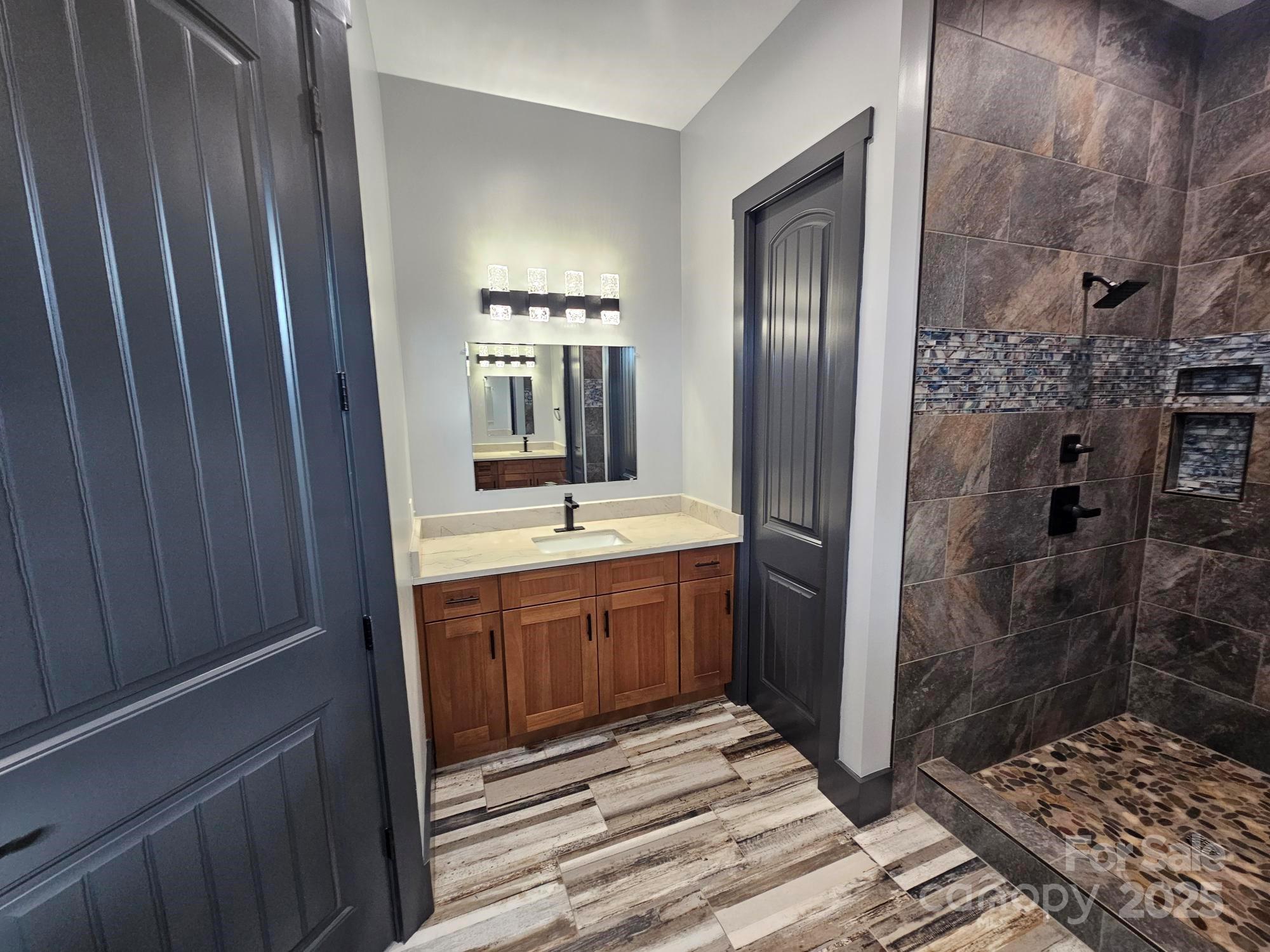 1076 Table View Drive, Unit 55 Morganton, NC 28655 - Photo 25 of 33 a bathroom with a sink and a mirror
