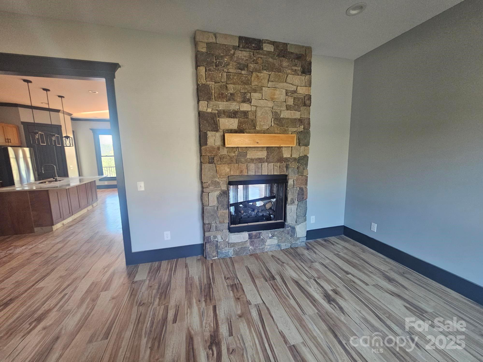 1076 Table View Drive, Unit 55 Morganton, NC 28655 - Photo 30 of 33 wooden floor fireplace and natural light in room