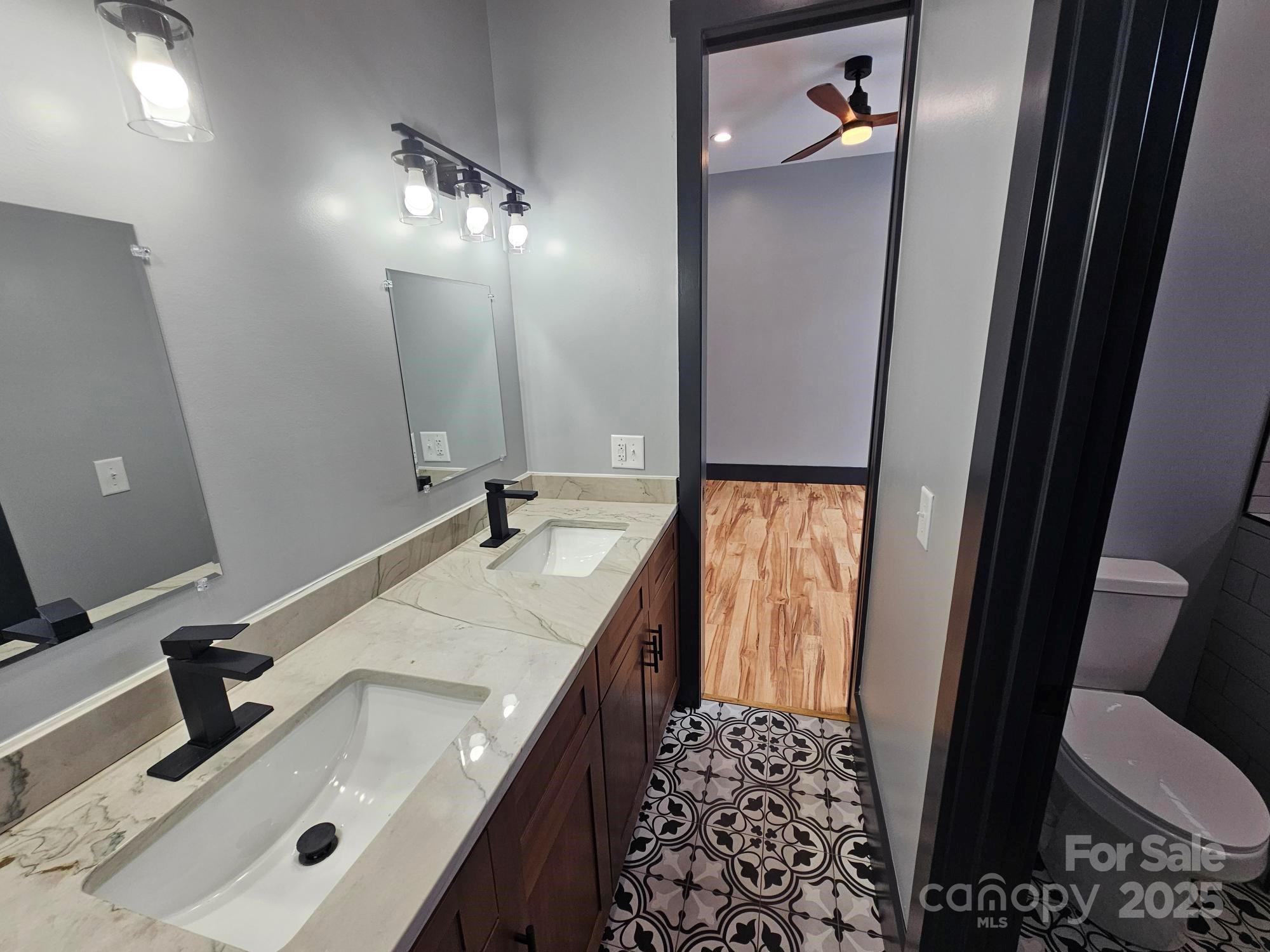 1076 Table View Drive, Unit 55 Morganton, NC 28655 - Photo 3 of 33 a bathroom with a sink and mirror with toilet