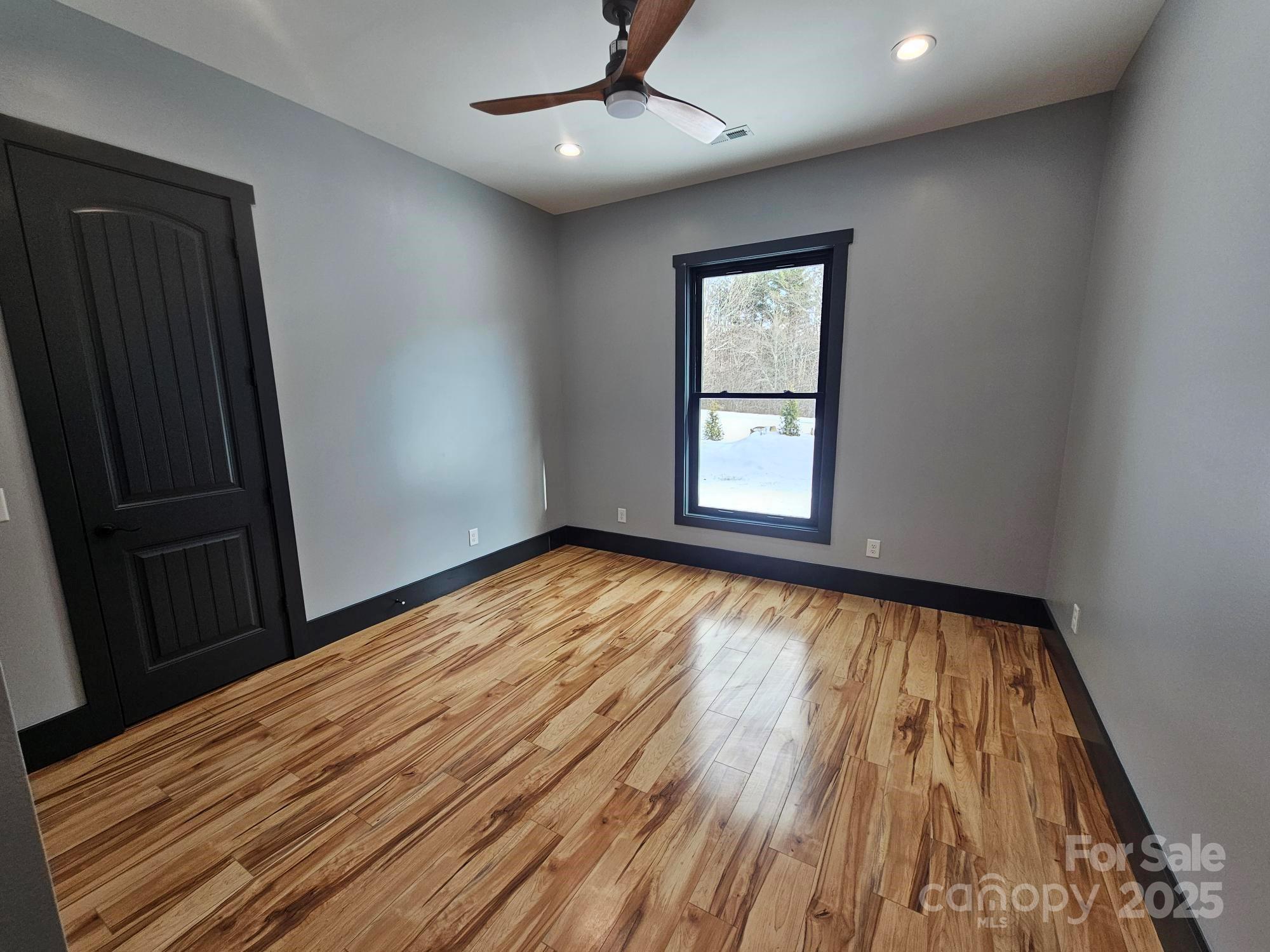 1076 Table View Drive, Unit 55 Morganton, NC 28655 - Photo 5 of 33 wooden floor in an empty room with a window