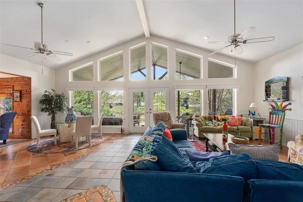 a living room with patio furniture and a large window