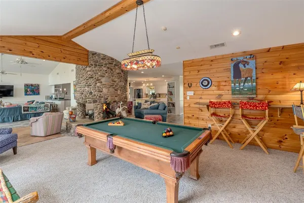 a room with table tennis pool table and chairs