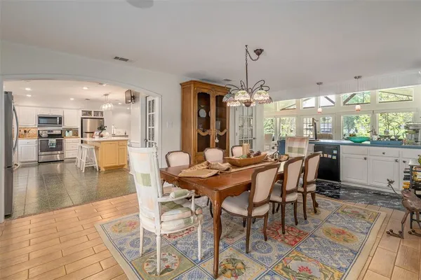 a dining room with furniture window and wooden floor