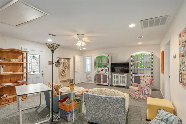 a living room with fireplace furniture and a chandelier