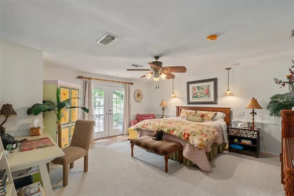 a bedroom with bed and glass door