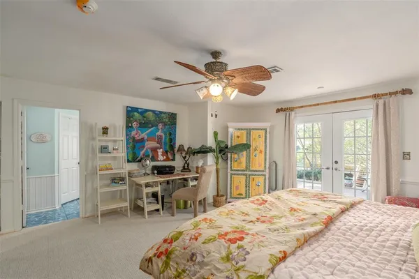 a bedroom with a bed and a large window
