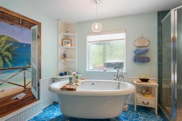 a bathroom with a tub sink and mirror