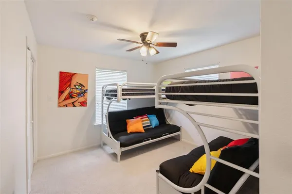 a room with furniture and ceiling fan