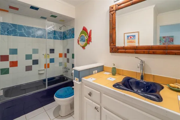 a bathroom with a sink a toilet and a shower curtain
