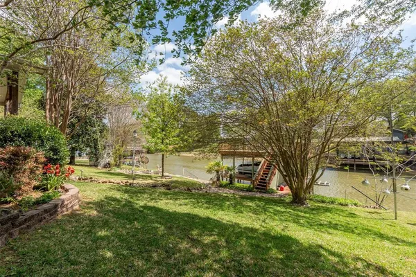 a backyard of a house with lots of green space and fountain