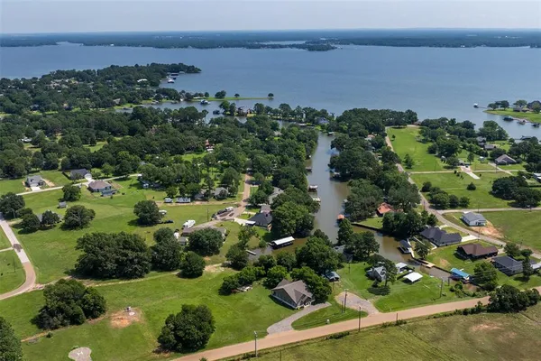an aerial view of a residential houses with outdoor space and garden