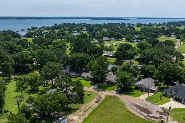 an aerial view of a houses with a yard