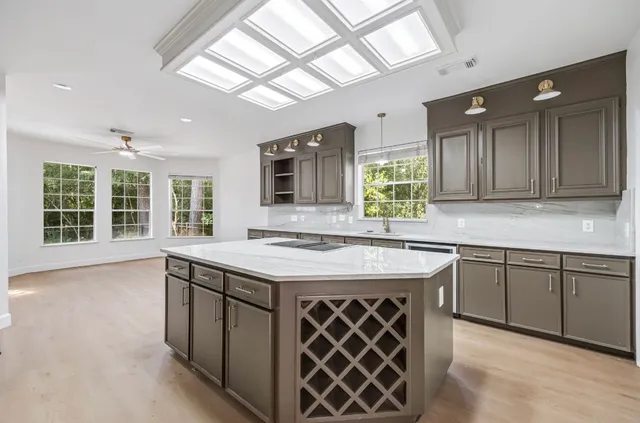 a kitchen with a stove a sink and a wooden cabinets
