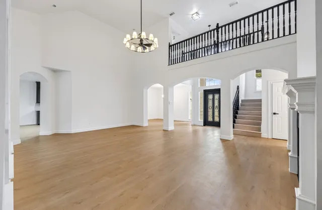a view of a livingroom with wooden floor and stairs