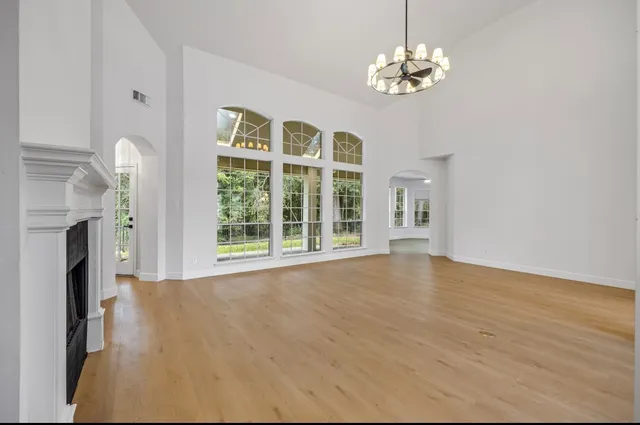 a view of livingroom with window fireplace and a chandelier