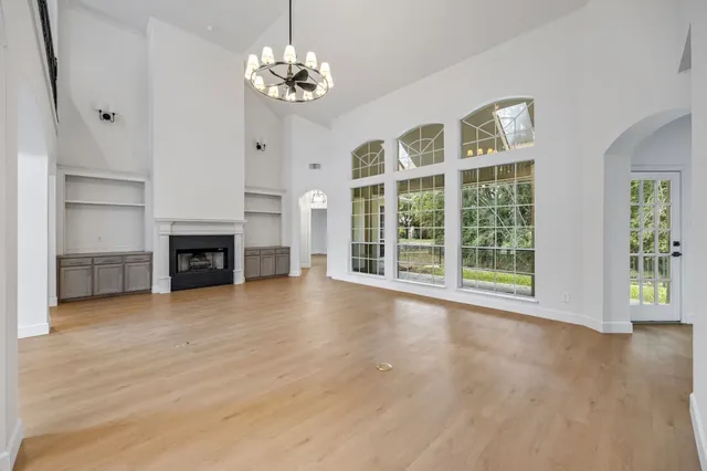 a view of livingroom with furniture chandelier and fireplace