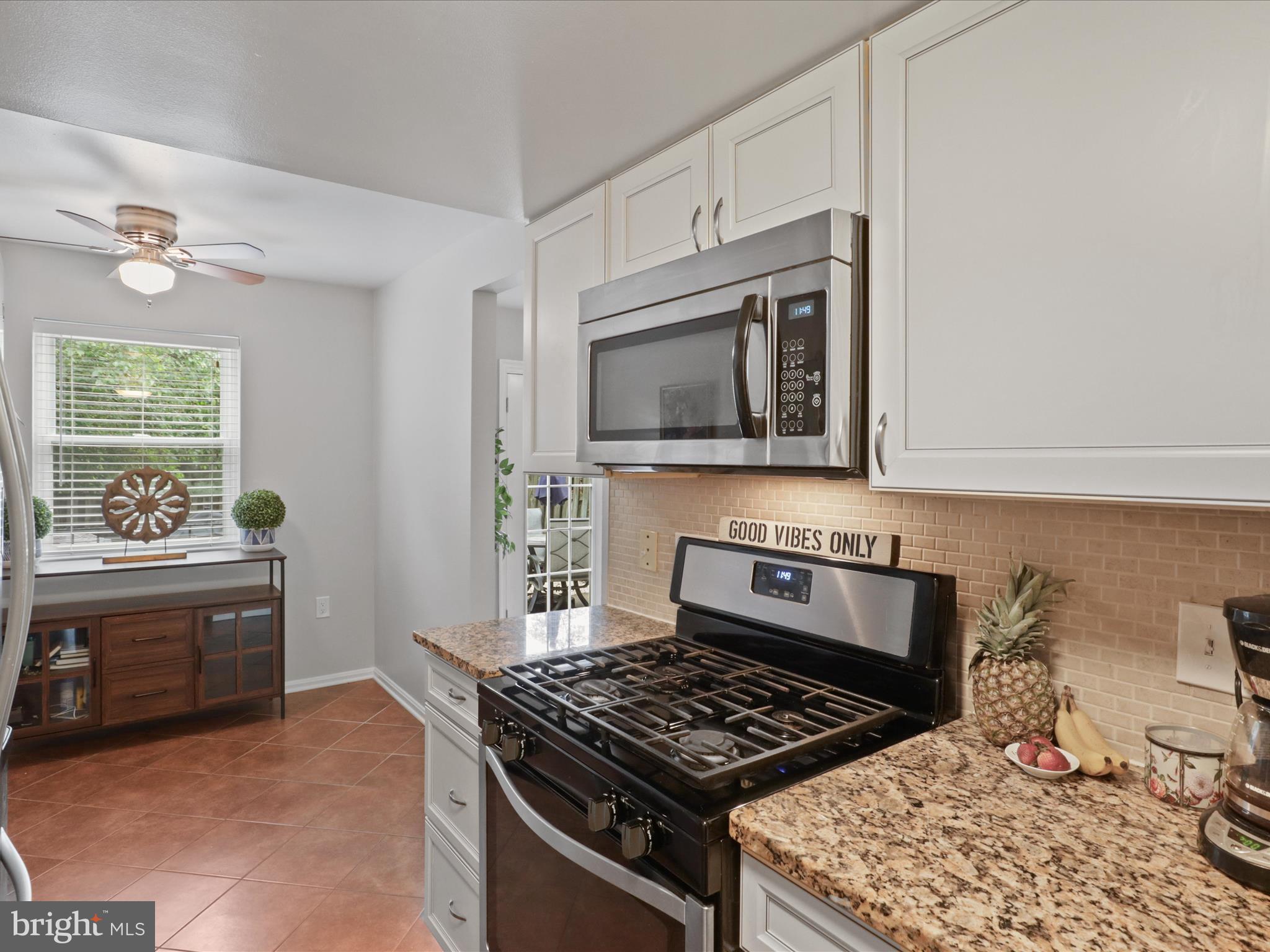 6558 Gildar Street Alexandria, VA 22310 - Photo 12 of 53 a kitchen with granite countertop a stove and a sink