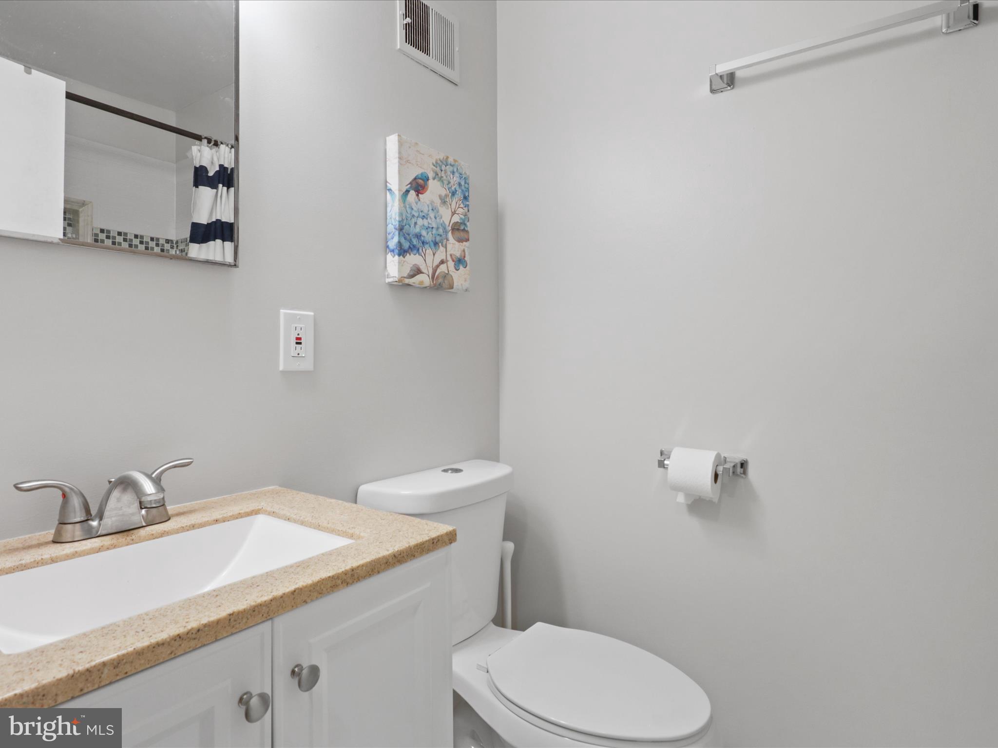 6558 Gildar Street Alexandria, VA 22310 - Photo 13 of 53 a bathroom with a granite countertop sink and a toilet