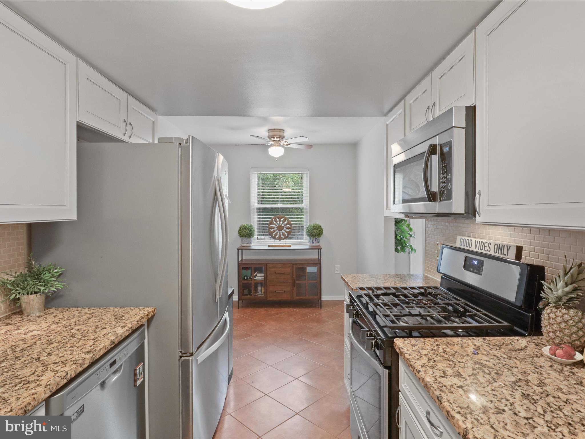 6558 Gildar Street Alexandria, VA 22310 - Photo 10 of 53 a kitchen with kitchen island granite countertop a sink stove and refrigerator