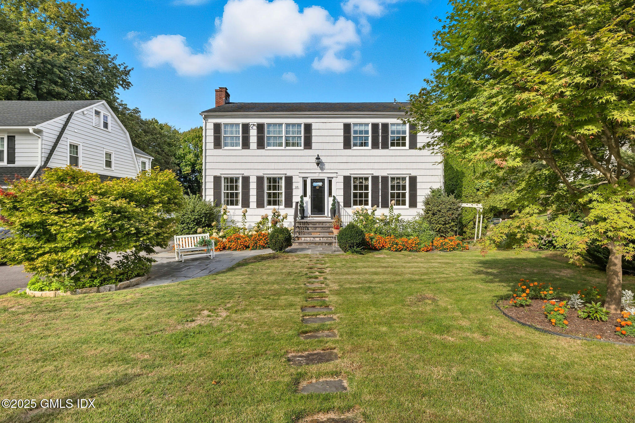 a front view of a house with garden