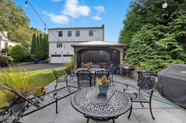 a view of a house with swimming pool and sitting area