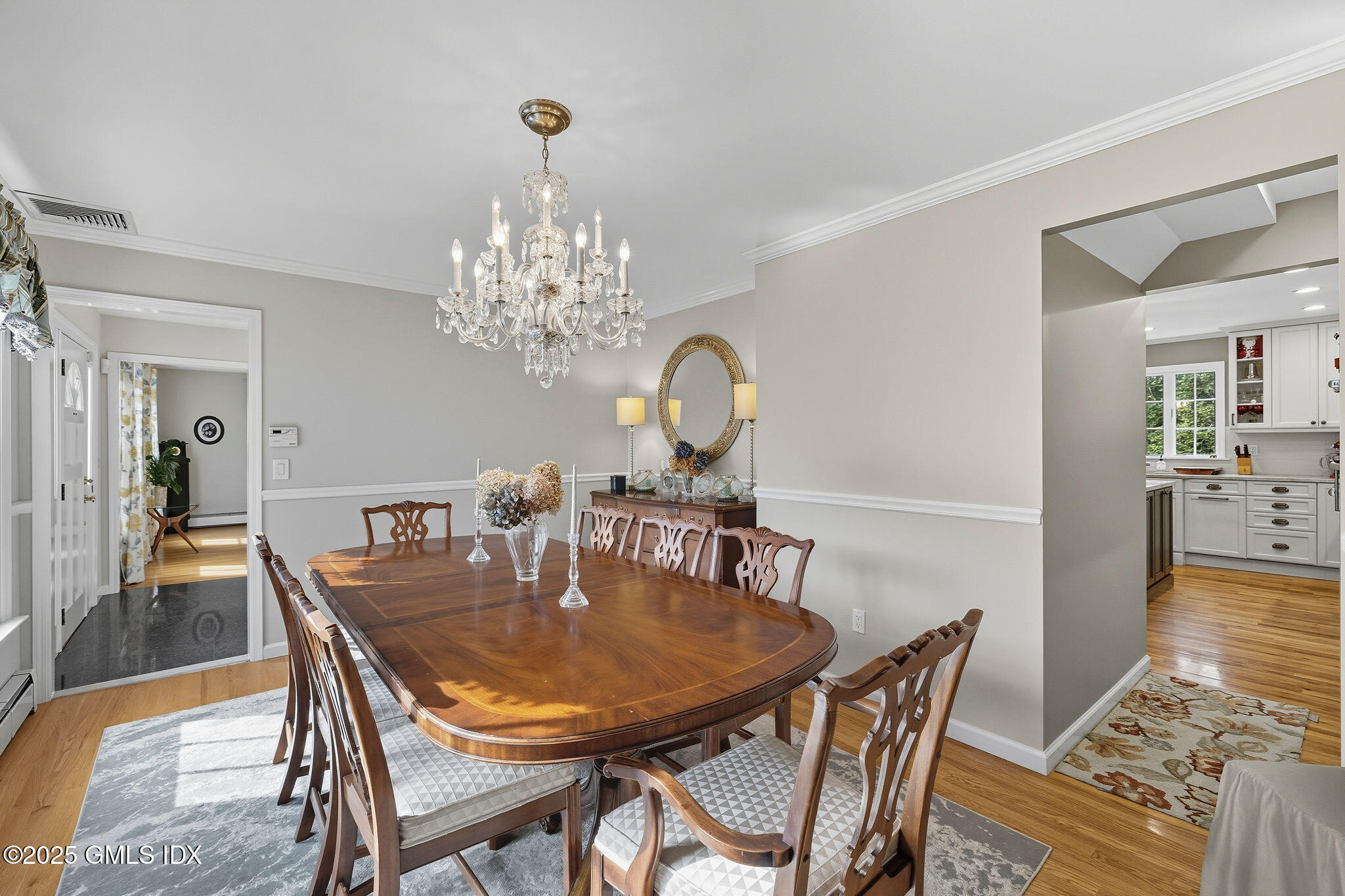 25 Buxton Lane Riverside, CT 06878 - Photo 7 of 16 a dining room with furniture a chandelier and wooden floor