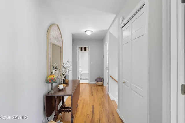 a view of a room with wooden floor and furniture