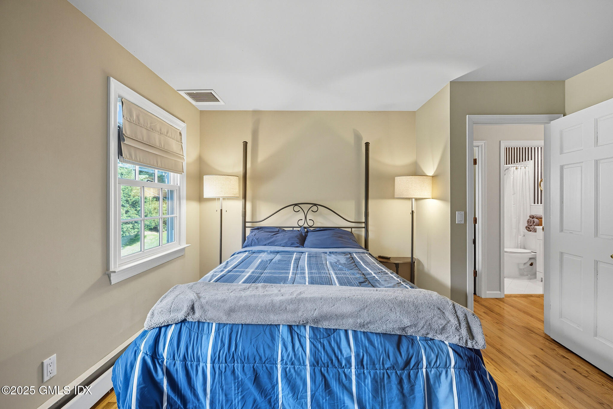 25 Buxton Lane Riverside, CT 06878 - Photo 10 of 16 a view of a bedroom with a bed and wooden floor