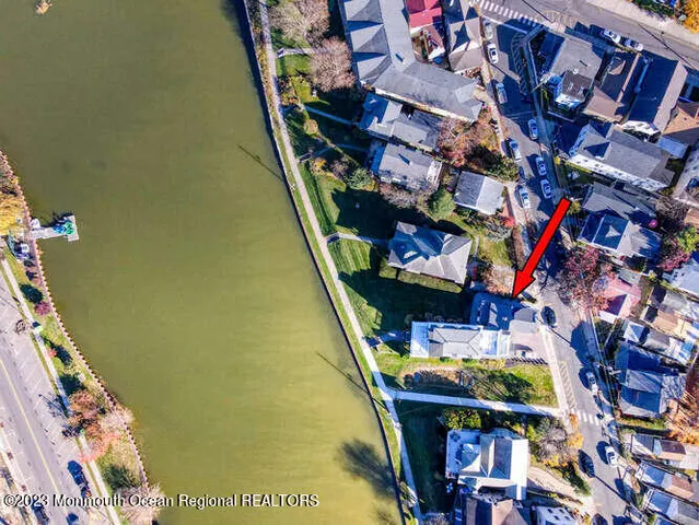 a blue couch sitting in a living room next to a window