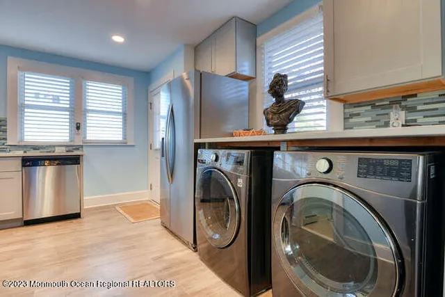 a bathroom with a tub a sink and a window