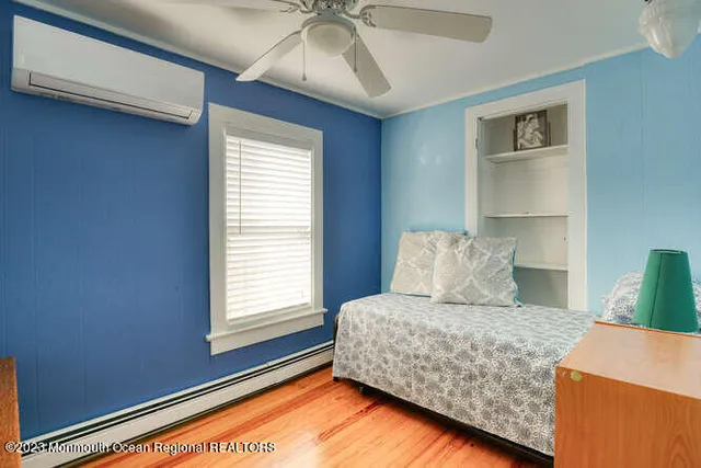 a bed sitting in a bedroom next to a window