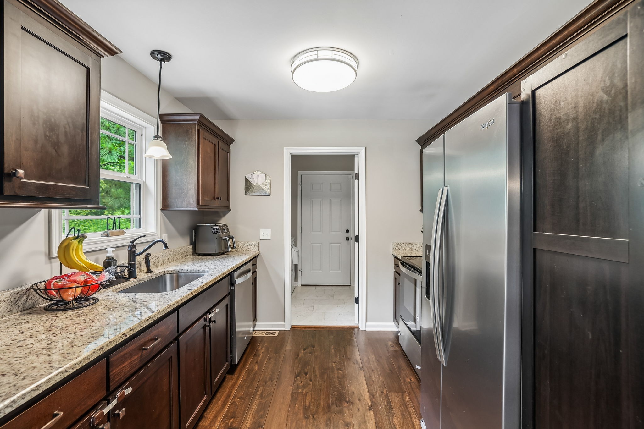 1546 South Spring Street Manchester, TN 37355 - Photo 20 of 53 a kitchen with stainless steel appliances granite countertop a refrigerator a sink and wooden cabinets