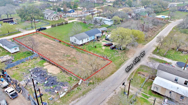 an aerial view of a house with a yard basket ball court and outdoor seating