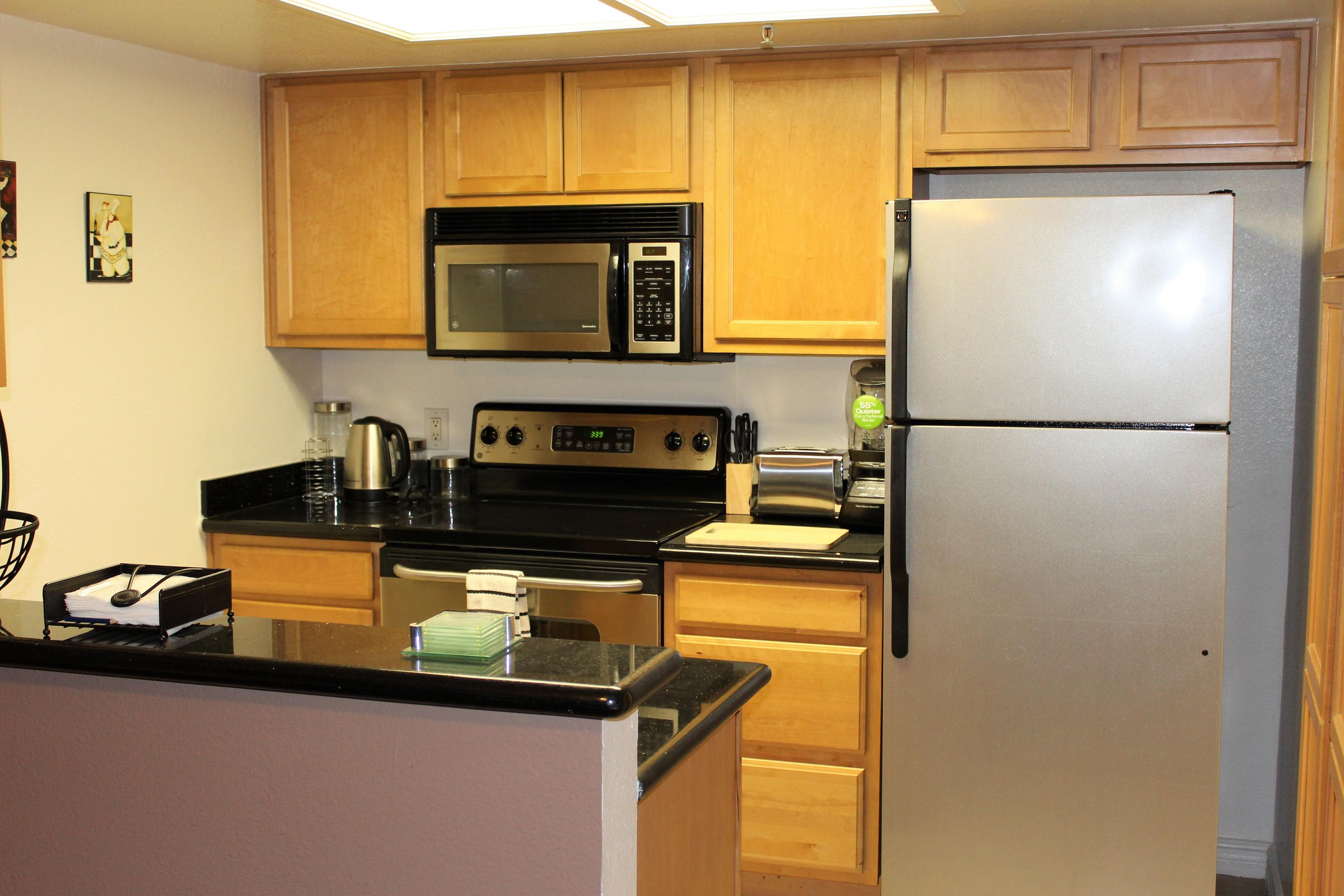 43376 Cook Street, Unit 88 Palm Desert, CA 92211 - Photo 4 of 13 a white refrigerator freezer sitting in a kitchen