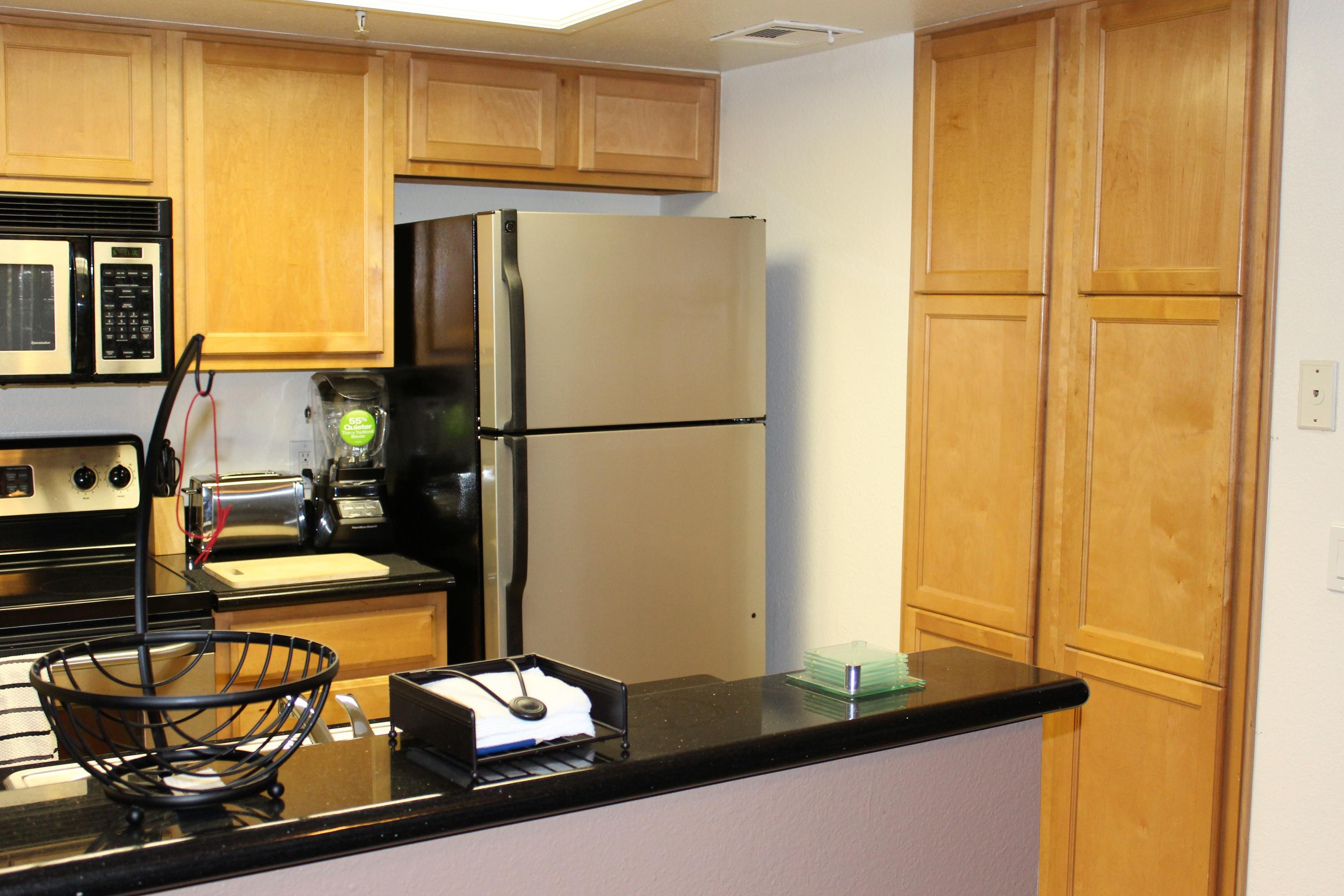 43376 Cook Street, Unit 88 Palm Desert, CA 92211 - Photo 5 of 13 a kitchen with a refrigerator and table