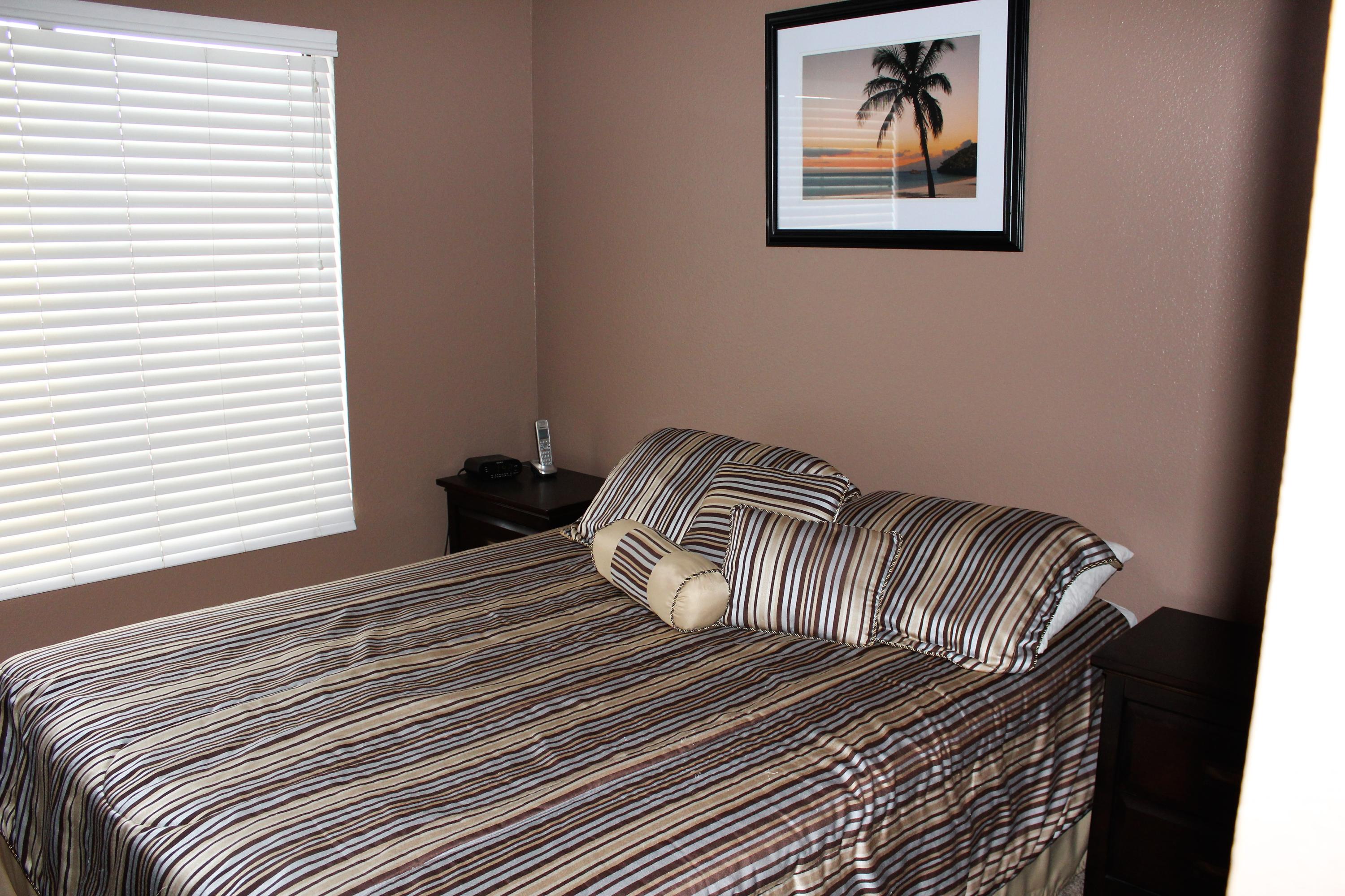 43376 Cook Street, Unit 88 Palm Desert, CA 92211 - Photo 6 of 13 a bedroom with a bed and a painting on the wall