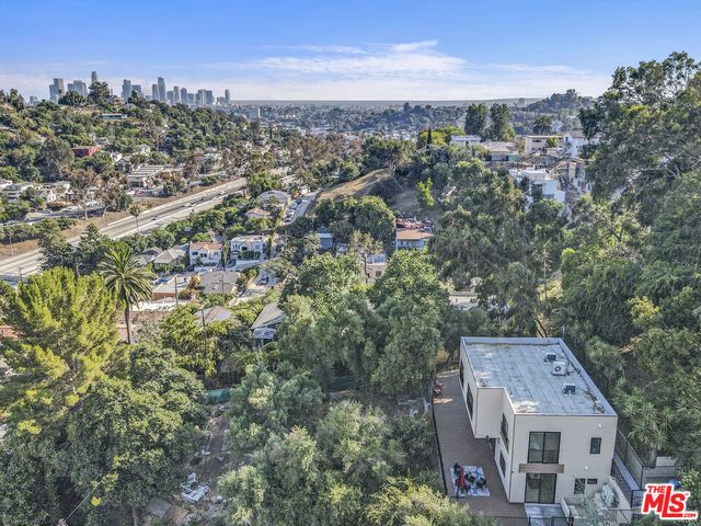 an aerial view of residential houses with city view