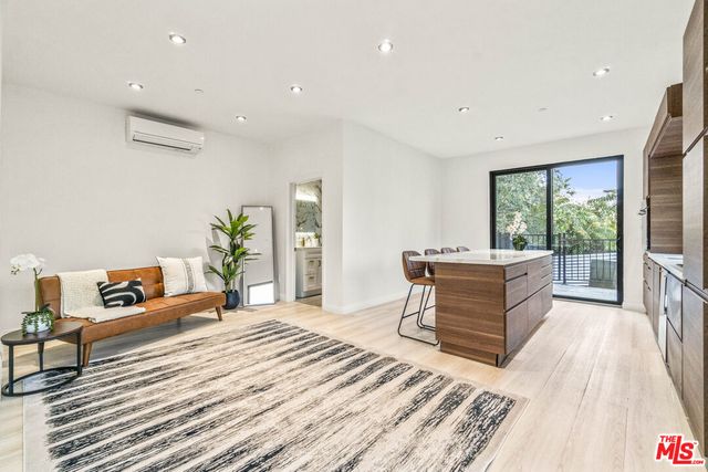 a bedroom with furniture and a wooden floor