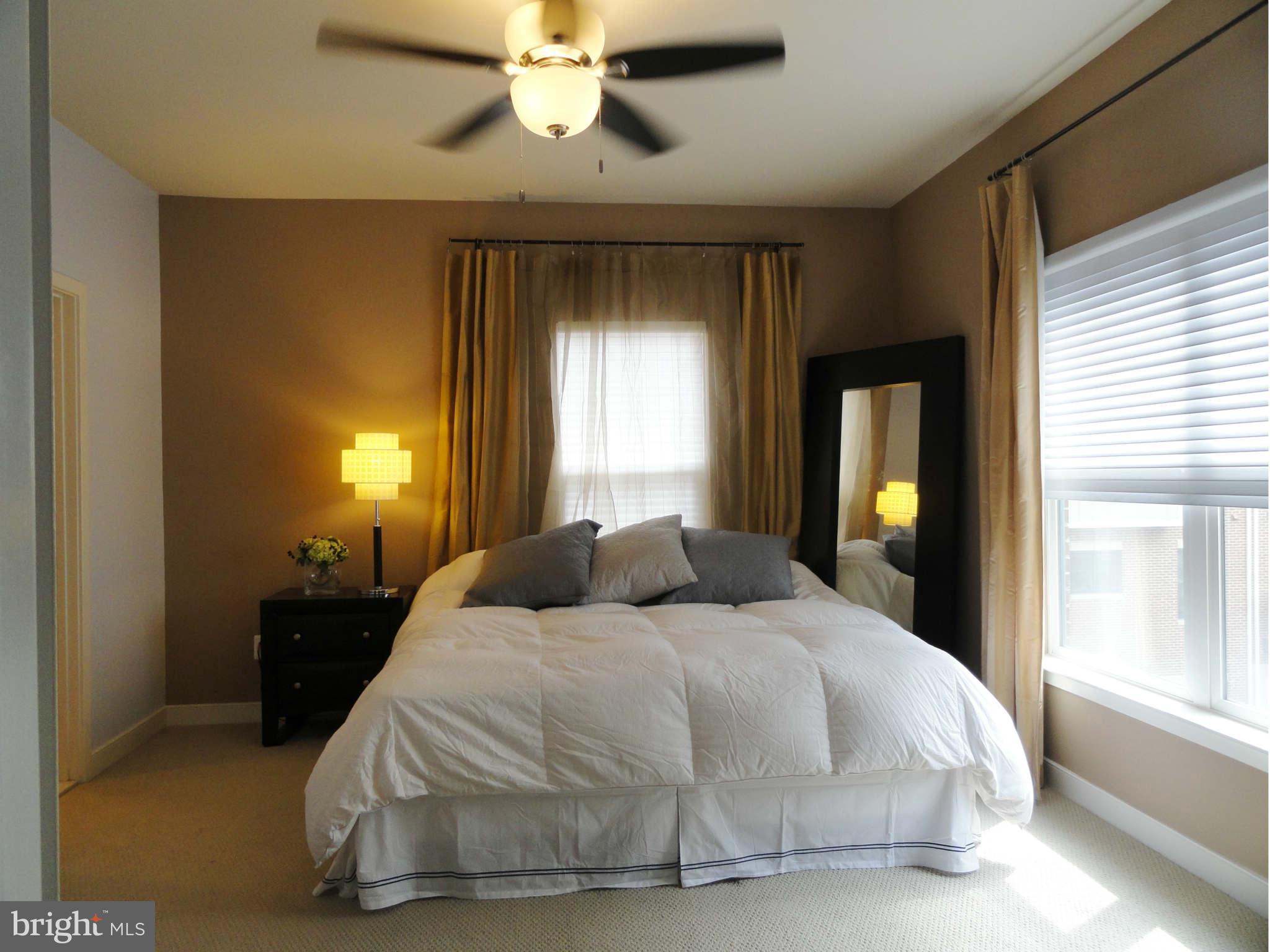 4159 Legato Road Fairfax, VA 22033 - Photo 11 of 25 a bedroom with a bed and a chandelier