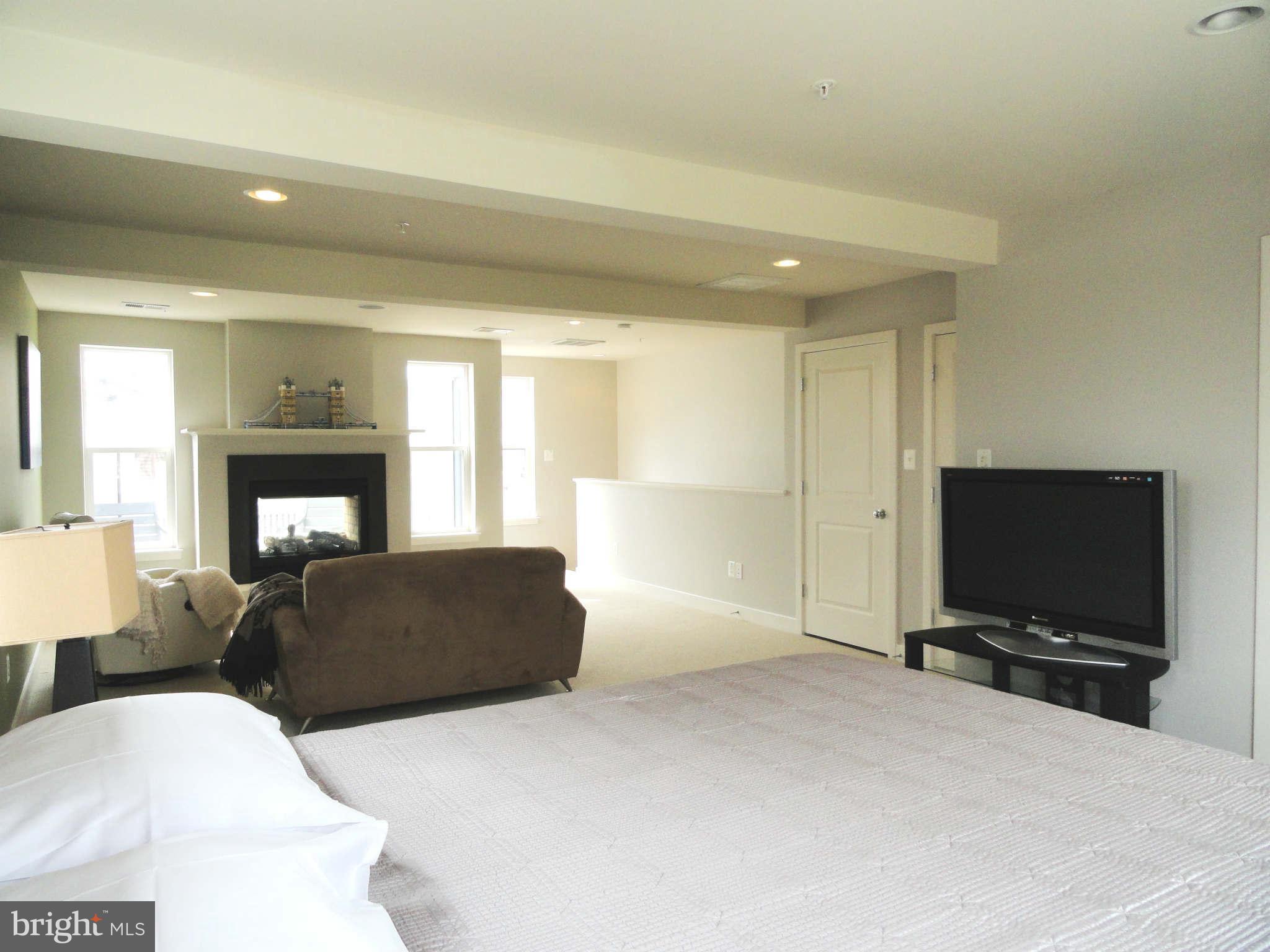 4159 Legato Road Fairfax, VA 22033 - Photo 14 of 25 a living room with furniture and a flat screen tv