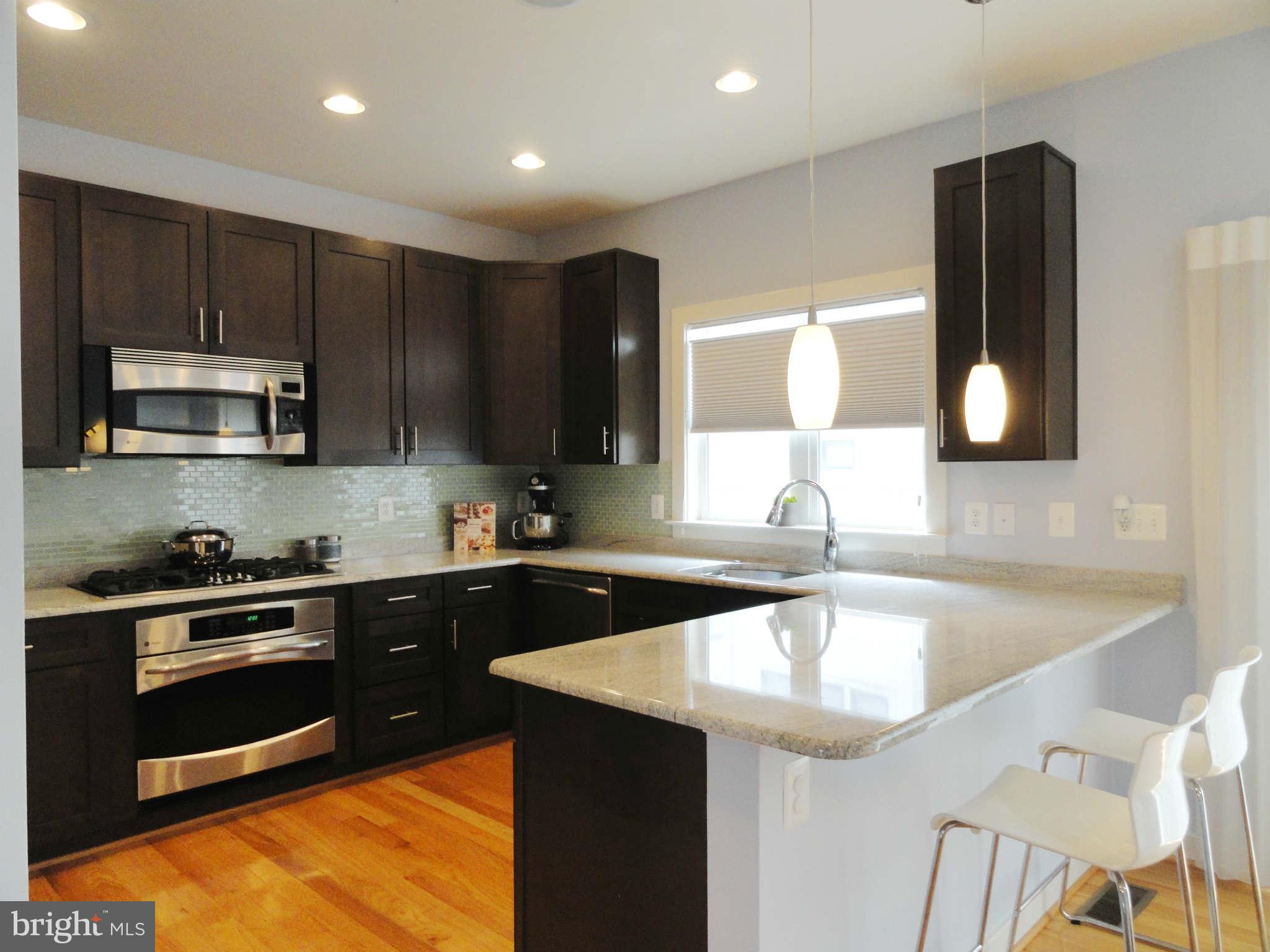 4159 Legato Road Fairfax, VA 22033 - Photo 7 of 25 a kitchen with a sink a stove and cabinets